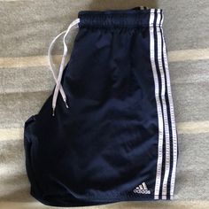 Washed/Never Worn Drawstring Waist 8 Inch Inseam 19inch Waist To Bottom Length Side Seam Pockets Navy Blue Summer Sportswear Bottoms With Three Stripes, Sportswear Athletic Shorts For Beach In Summer, Sportswear Athletic Shorts For Summer Beach, Summer Beach Sportswear Athletic Shorts, Adidas Sportswear Shorts For Summer, Adidas Summer Sportswear Shorts, Summer Beach Athletic Shorts, Navy Short Swimming Bottoms, Three Stripes Gym Bottoms For Summer