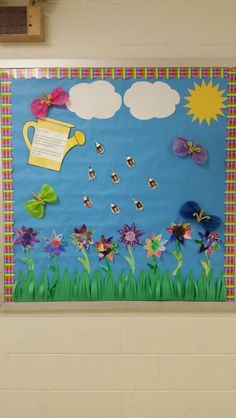 a bulletin board with flowers, butterflies and a watering can on it's side