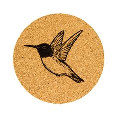 a cork coaster with a bird drawn on it