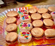 there are many different types of cookies in the tray on the table and one is decorated with flowers