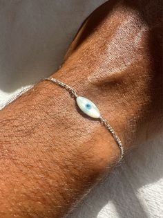 Introducing the ultimate accessory for men - the Evil Eye Bracelet for Men Handmade with Love. Handcrafted in Greece, this bracelet showcases exquisite craftsmanship and a unique design. Adorned with a captivating evil eye charm made from lustrous mother of pearl, this bracelet is threaded through a sterling silver chain, ensuring the highest quality and durability. With four different lengths available, you can find the perfect fit for your wrist. Designed to elevate your style and provide time Men Silver Chain, Jewelry Evil Eye, Greek Men, Mens Chain Bracelet, Bracelet Evil Eye, Silver Chain For Men, Types Of Gifts, Bracelet Men, Silver Chain Bracelet