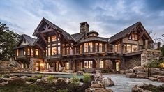 a large house with lots of windows and rocks