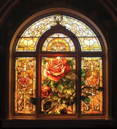 a stained glass window with roses on it