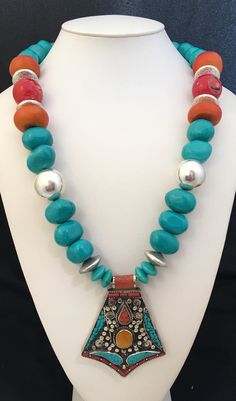 "Bold, colorful African inspired multi-stone statememt piece. Berber pendant of silver, turquoise, red coral, yellow agate. Turquoise nuggets Moroccan amber beads Red coral Silver beads Orange/red and silver box clasp LENGTH: 26-1/4OA  \"BERBER DANCER\"" Bohemian Turquoise Necklace With Large Multicolor Pendant, Bohemian Multicolor Turquoise Necklace With Large Pendant, Unique Multicolor Turquoise Pendant Necklace, Artisan Multicolor Turquoise Pendant Necklace, Multicolor Turquoise Pendant Necklace, Spiritual Style, Yellow Agate, Red And Silver, Amber Beads, Silver Box