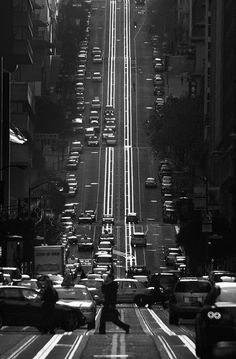 a black and white photo of traffic on a city street