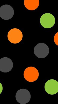 an orange and green polka dot pattern on a black background