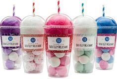 six bubble pops are in plastic cups with straws on top and one is filled with marshmallows