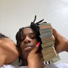 a man and woman hugging each other with stacks of money in front of their faces