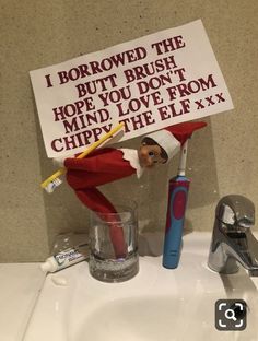 an elf with a toothbrush and sign on the sink