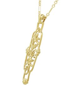 This unique vintage-inspired Art Nouveau filigree necklace in yellow gold vermeil is an exact artisan crafted replica of a classic cartouche necklace design dating from 1910.Measuring 2 inches high by 1/2 inch wide, this uncommon Art Nouveau antique floral filigree lilies pendant design includes a coordinating vintage style long and short paperclip design neck chain of 18 inches in yellow gold finished sterling silver.An elegant gift box is included with this perfect piece for an Art Nouveau jew Cartouche Necklace, Art Nouveau Antiques, Floral Filigree, Vintage Inspired Art, Filigree Necklaces, Antique Floral, Art Nouveau Jewelry, Necklace Design, Neck Chain