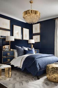 a bedroom decorated in blue and gold with pictures on the wall, chandelier and bed