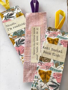 Add a touch of charm to your reading nook with one of these handmade bookmarks, each featuring a quote related to reading.  📏6 inches x 2 inches 🧵Machine Sewn 🫶Each bookmark is handmade and will feature visual differences from the photos.   Crafted from cotton fabric and luxurious velvet ribbon, these bookmarks are designed to be both elegant and durable. Two bookmarks showcases a multi colored  butterfly print and the other features a whimsical print of book text, perfect for bibliophiles.  These are ideal for marking your place in any story, making them a thoughtful gift for book lovers or a special treat for yourself. 📖✨ Embroidered Book Marks, Bookmark Quotes, Bookmark Holder, Fabric Bookmarks, Cheeky Quotes, Book Text, Colored Butterfly, Handmade Bookmarks, Craft Booth Displays