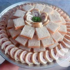 a platter filled with sandwiches and meats