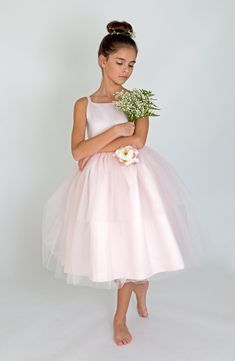 A soft grosgrain bow and detachable flower adorn the waist of a sweet, ballerina-inspired dress fashioned with thin straps and a full skirt of floaty, layered tulle. Hidden back zip closure and decorative buttons Ballet-length Fully lined 100% polyester bodice with nylon tulle skirt Dry clean or hand wash cold, line dry Imported Kids' Wear Bridesmaid Boutique, Junior Bridesmaids, Girls Communion Dresses, Bridal Gallery, The Ballerina, Ballerina Dress, Layered Tulle Skirt, Communion Dresses