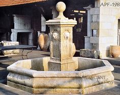 an old fountain in the middle of a courtyard