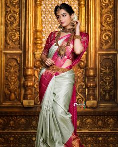 a woman in a pink and green sari