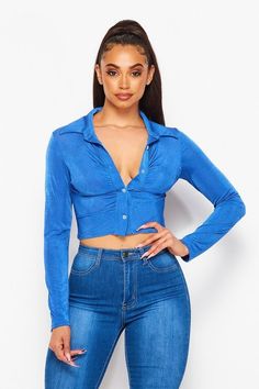 Turn heads and capture hearts with our vibrant Stretch Long Sleeve Crop Shirt, a show-stopper that effortlessly blends style with comfort. This chic top, with its figure-hugging ribbed texture and captivating color, is designed for the modern woman who's not afraid to stand out. The playful cropped length makes it a versatile piece to pair with high-waisted jeans or skirts, while the long sleeves and buttoned front provide both warmth and adjustable coverage. A seamless blend of bold and classy, this crop shirt is sure to become a staple in your fashion-forward wardrobe. 🌟 Sleeve Design: Long sleeves perfect for transitional weather, adding both style and practicality. Closure: Secure front-button closure allows for easy wear while adding a touch of classic charm. Collar Detail: A soft tu V-neck Stretch Top With Button Closure, Trendy Non-stretch Top With Button Closure, Stretch V-neck Tops With Button Closure, Solid Stretch Button-up Tops, Blue Stretch Collared Blouse, Fitted Long Sleeve Tops With Buttons, Collared Stretch Top With Button Closure, Non-stretch V-neck Tops With Button Closure, Non-stretch V-neck Top With Button Closure