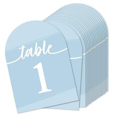 a set of blue table numbers with the number one on each place card, in white lettering