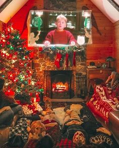 a living room filled with furniture and a fire place next to a christmas tree in front of a flat screen tv