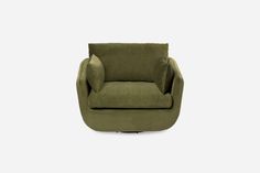 the green chair is sitting in front of a white wall and it's legs are up