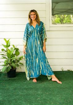 "Add a touch of unique style to your wardrobe with our Hand-Dyed Kaftan Dress! This stunning dress is made from 100% breathable and comfy rayon fabric, ensuring maximum comfort all day long. Using the traditional Shibori method, each dress is carefully hand dyed, resulting in a one-of-a- kind masterpiece. The intricate patterns and vibrant colors make this dress a true work of art. The kaftan dress comes in a versatile one size fits most (M-3XL), making it extremely comfortable for a wide range Tie Dye Natural Dye Dress For Beach Cover-up, Beach Cover-up Tie Dye Dress With Natural Dye, Tie Dye Natural Dye Dress For Beach, Green Batik Print Maxi Dress For Beach, Green Batik Print Dress For The Beach, Green Batik Print Dress For Festival, Indigo Bohemian Dress With Natural Dye, Indigo Bohemian Dress With Relaxed Fit, Green Festival Dress With Batik Print