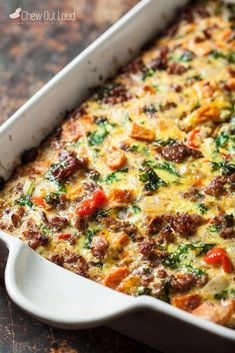 a casserole dish with meat, cheese and veggies in it on a table