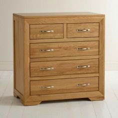 a wooden dresser sitting on top of a white floor