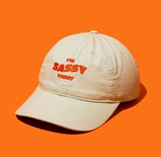 "Unleash your inner sass and let it speak volumes with our \"I'm Sassy Today\" embroidered dad hat. Crafted for those who embrace their boldness and wit, this hat isn't just an accessory--it's your cheeky sidekick on spirited days. Made from 100% organic cotton in a durable 3/1 twill, it's as resilient and forthright as you are. Perfect for adding a playful leap to your step and a twinkle to your outfit, it's the ultimate companion for expressing your vivacious spirit. Whether you're out for a c Fresh Hat, Kids Line, Organic Cotton Fabric, Style Expert, You Are Perfect, Dad Hat, Hat Making, Out Of Style, Trucker Cap