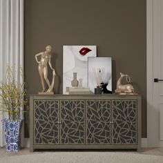 a sideboard with statues, vases and pictures on it in front of a door