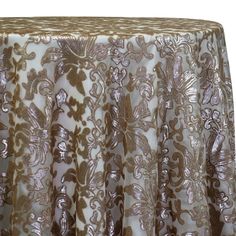 a gold and white table cloth with an intricate design on it's edge,