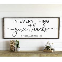 a wooden sign that says in every thing give thanks with some succulents