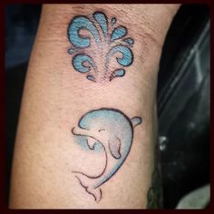 a dolphin tattoo on the left arm