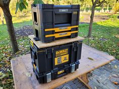 three boxes are stacked on top of each other in the middle of a picnic table