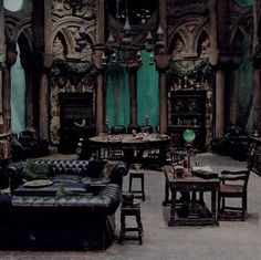 a living room filled with lots of furniture and walls covered in intricate carvings, including an ornate fireplace