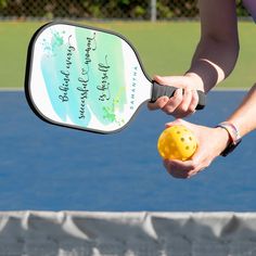 a person holding a tennis racket and ball