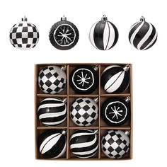 black and white ornaments are arranged in an open wooden box on a white background photo