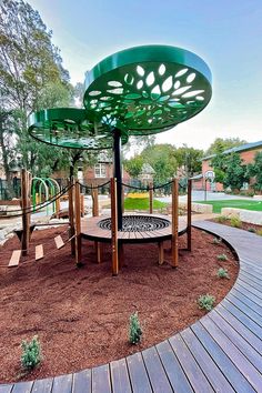 an outdoor playground with wooden benches and play equipment