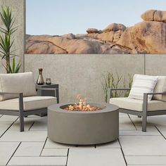 an outdoor fire pit with two chairs and a table in front of it on a patio