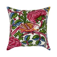 an embroidered pillow with pink flowers and green leaves on the front, sitting on a white background