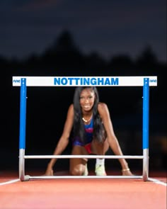 a woman is standing in front of a sign that says nottingham on it