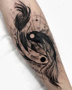 a black and white photo of a tattoo on someone's arm with a koi fish