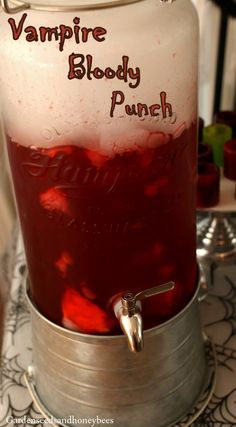 a large metal container filled with liquid on top of a table