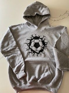 Soccer hoodie personalized. Custom soccer hoodie with name on the back or include team name. Great as a soccer team gift or gift for the coach!! Pullover hoodie with soccer ball design on front and name on the back. Different colors available. Contact Seller with custom requests. Sizing: S=6/6x, M=7/8, L=10/12, XL=14/16 Washing Instructions: 1. Turn garment inside out 2. Machine wash cold 3. No bleach 4. tumble dry on low 5. Do not iron Sports Season Hooded Sweatshirt With Kangaroo Pocket, Fleece Sweatshirt With Adjustable Hood For Sports Events, Team-colored Hoodie For Sports Season, Sports Fan Long Sleeve Hoodie For Winter, Fleece Hoodie For Sports Season, Fan Gear Hooded Sweatshirt With Drawstring, Winter Long Sleeve Sports Fan Hoodie, Team Spirit Hooded Hoodie For Fan Gear, Sports Fan Fleece Hoodie