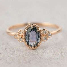 an oval shaped amethorate ring with three diamonds on the sides and a gold band