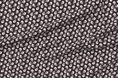 a black and white fabric with skulls on it