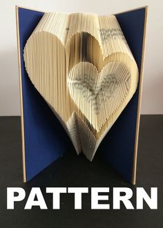 an open book with folded pages in the shape of a heart and text that reads pattern