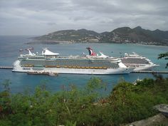 two cruise ships are docked in the water