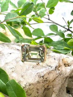 This beautiful 5-carat Green Amethyst ring features 0.06-carat diamonds set in timeless yellow gold. The vivid hue of the Green Amethyst will be sure to turn heads and give a unique twist to any outfit. This ring features:-5.00 carat Green Amethyst-0.06 carat Diamond-14KT Yellow Gold Can be made in any sizeStyle #200-00406 Luxury Gold Ring With Green Amethyst, Luxury Yellow Gold Amethyst Ring With Emerald Cut, Yellow Gold Emerald-cut Amethyst Ring For Formal Occasions, Yellow Gold Sapphire Ring With Emerald Cut, Elegant Green Topaz 14k Gold Ring, Classic Formal Emerald Ring With Gemstone Accents, Elegant Green Topaz Ring In 14k Gold, Elegant Octagon Amethyst Ring For Formal Occasions, Yellow Gold Ring With Green Amethyst And Accent Stones