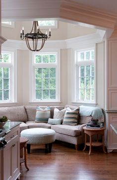 a living room filled with furniture and windows