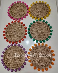 four crocheted coasters with colorful beads on them